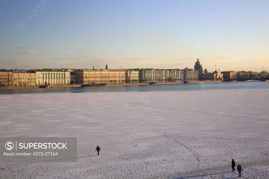 Russia, St.Petersburg; People walking across the partly frozen Neva River.