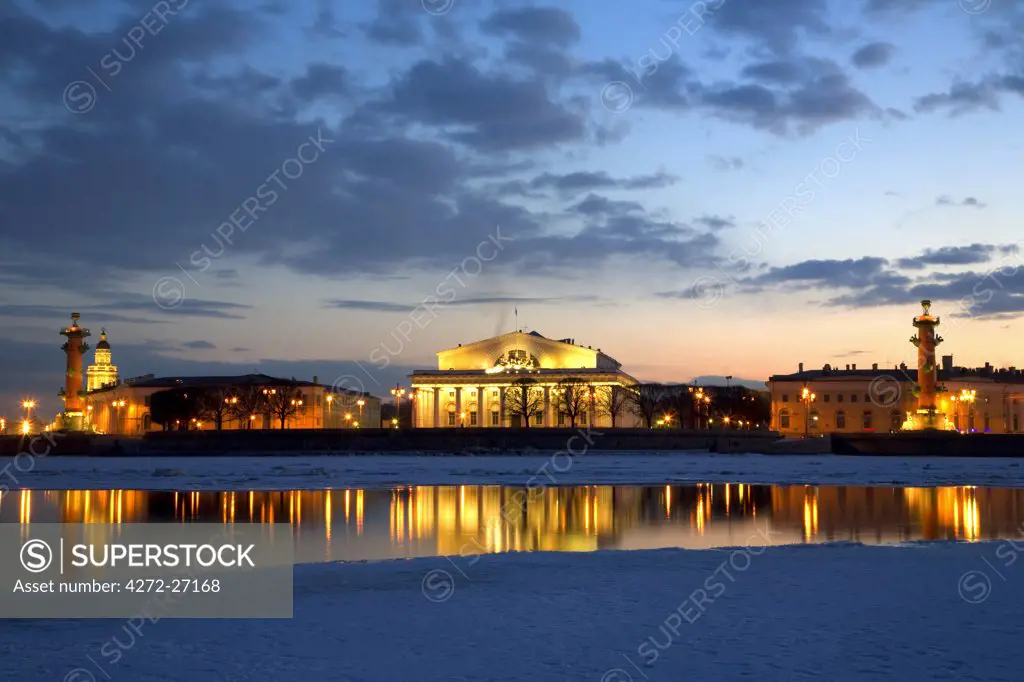 Russia, St.Petersburg; The partly frozen Neva River with the Maritime Musem & two rostral columns.
