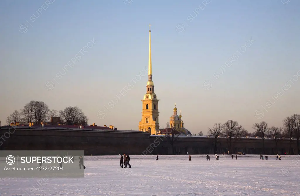 Russia, St.Petersburg; People walking on the frozen Neva River just in front of St.Peter and St.Paul's Fortress