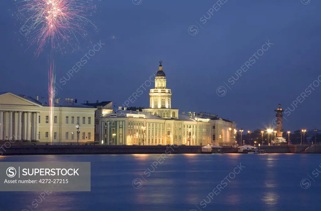 Russia, St.Petersburg; Across the Neva River with the Kunstkamera and a Rostral column while fireworks are being shot