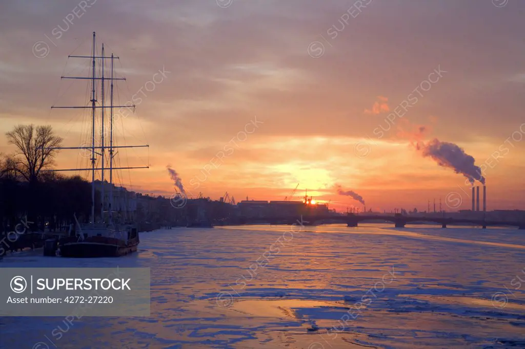 Russia, St.Petersburg; A dramatic view over the Neva River in Winter at sunset