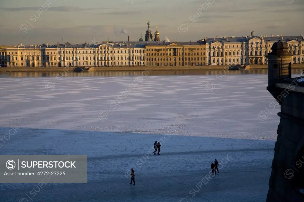 St.Petersburg, Russia; People walking on the frozen ice of the Neva River in central St.Peterburg in front of the palaces.