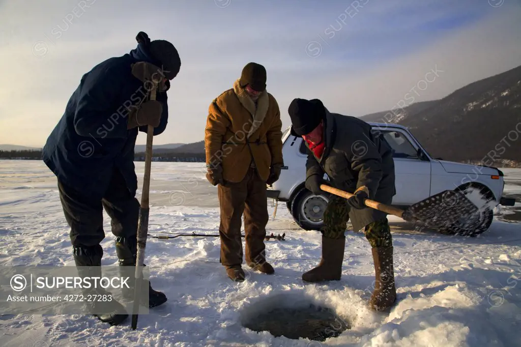 Russia, Siberia, Severo-Baikalsk. Undergoing preparations to fish on frozen Lake Baikal, in Winter the Lake can hold a car