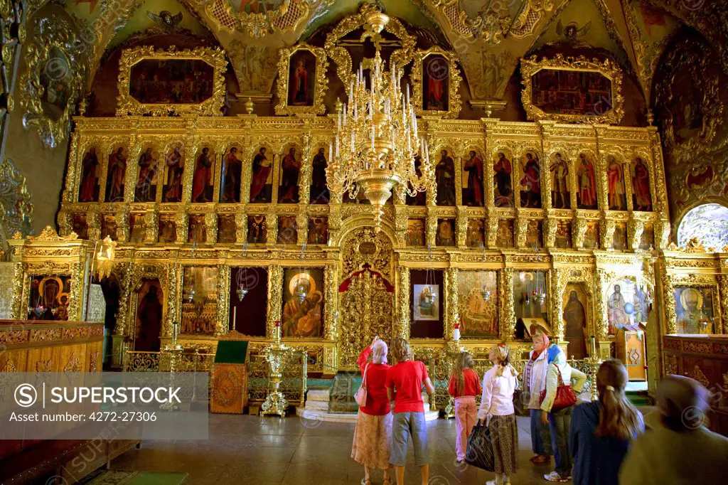 Russia. Visitors in one of the cathedrals in the Trinity Monastery of St.Sergius. Sergiev Posad.