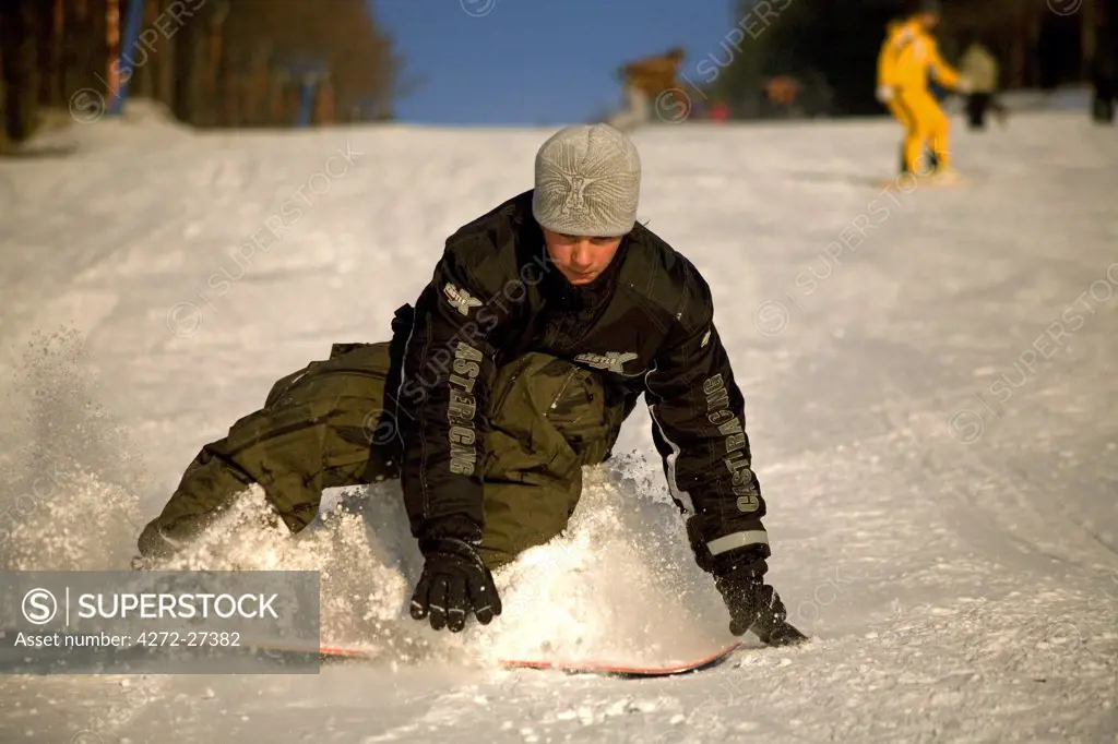 Russia, Far East, Sakhalin, Yuzhno-Sakhalinsk; A youth stopping on one of the hills of Sakhalin's capital