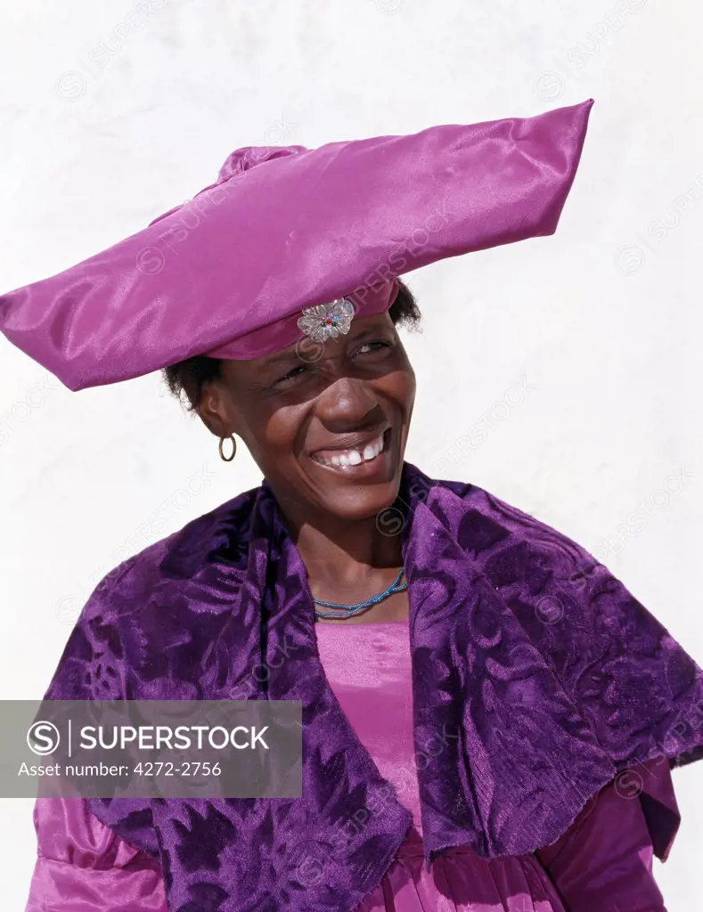 An Herero woman in traditional attire. The origins of the elaborate dress and unique hat style of Herero women can be traced back to 19th century German missionaries who took exception to what they considered an immodest form of dress among the tribe at that time.