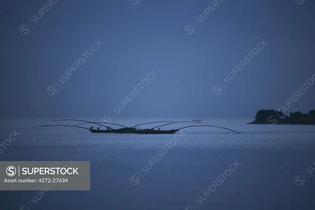 Gisenyi, Rwanda. Night fishermen head out onto lake Kivu with specially adapted boats.