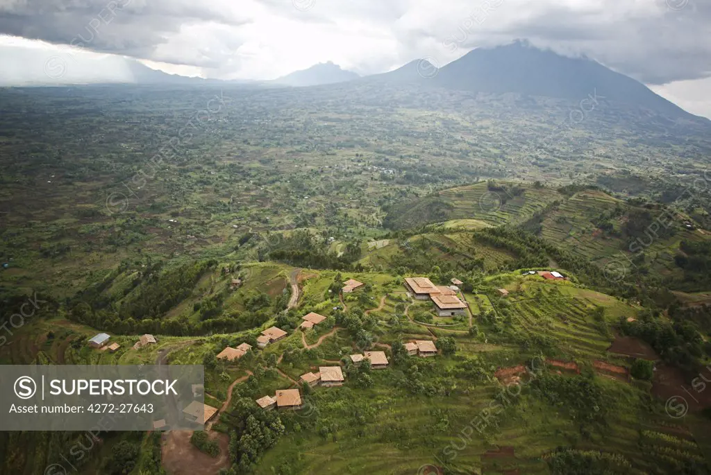 Rwanda. The luxurious Virunga Safari Lodge sits below looming volcanoes. Tourists use the hotel as a base from which to trek with mountain gorillas.