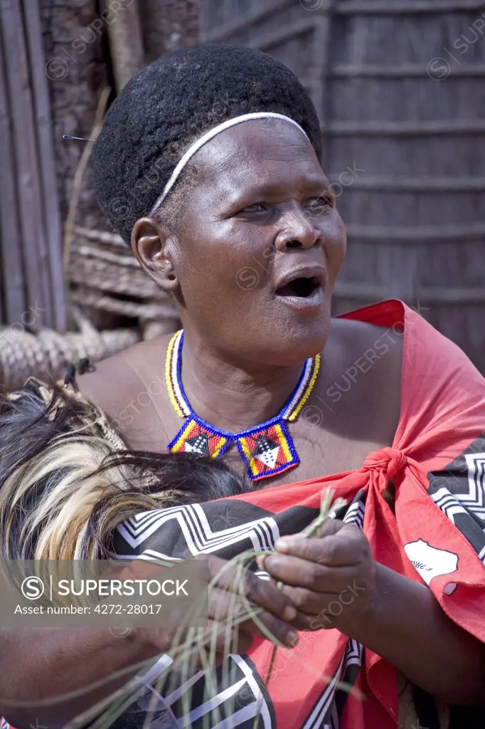 A Swazi woman demonstrates traditional skills in a village in Milwane Game Reserve, Swaziland.