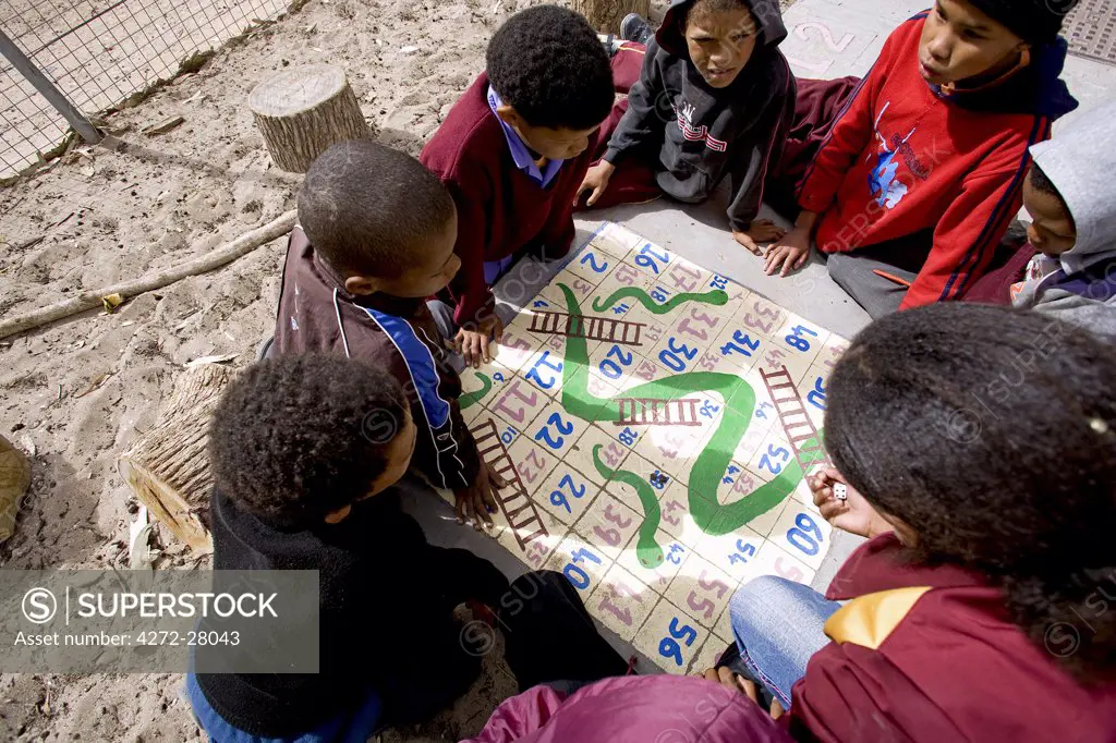 South Africa, Western Cape, Elands Bay. Looking down on a game of 'snakes and ladders' in the playground of a small town school on the Western Cape's Atlantic Coast.