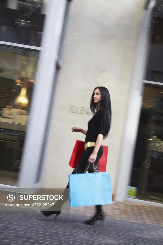 Woman walking with shopping bags at Melrose Place, Melrose, Johannesburg, Gauteng, South Africa (MR)