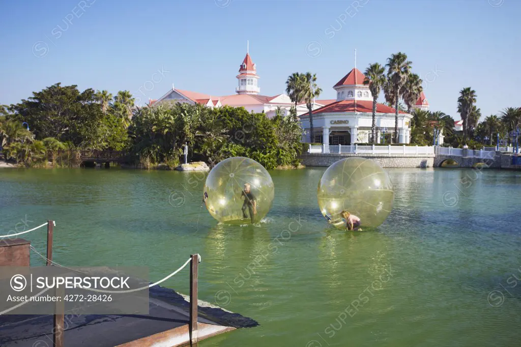 Children playing in inflatable balls on lake at the Boardwalk entertainment complex, Summerstrand, Port Elizabeth, Eastern Cape, South Africa