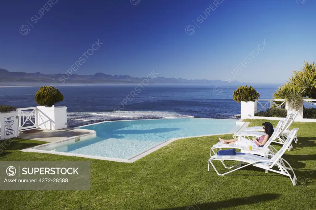Woman relaxing poolside at Plettenberg Bay Hotel, Plettenberg Bay, Western Cape, South Africa (MR)