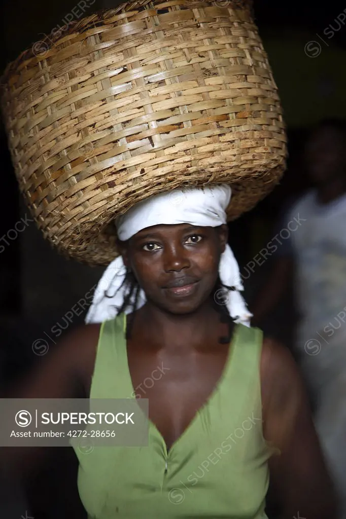 A Sao Tomense woman carries a basket full of cocoa beans at the cocoa processing plant in Agua Ize, a small Sao Tomense village. Cocoa is the country's chief export. Sao Tome and Principe is Africa's second smallest country with a population of 193 000. It consists of two mountainous islands in the Gulf of New Guinea, straddling the equator, west of Gabon.