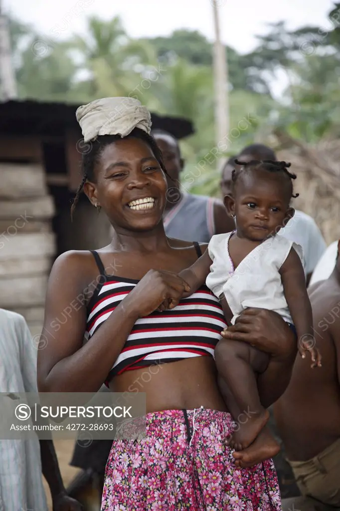 A Sao Tomense woman laughs while holding her baby on the island of Princip_. Sao Tom_ and Princip_ is Africa's second smallest country with a population of 193 000. It consists of two mountainous islands in the Gulf of New Guinea, straddling the equator, west of Gabon.