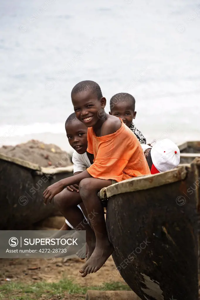 Children sit on a fishing boat made of bamboo in the village of Porto Alegre in the south of Sao Tom_ and Princip_. Sao Tom_ and Princip_ is Africa's second smallest country with a population of 193 000. It consists of two mountainous islands in the Gulf of New Guinea, straddling the equator, west of Gabon.
