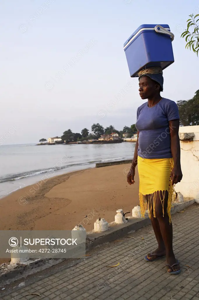 A street seller walks along the 'Baia de Ana Chaves' (Bay of Ana Chaves. Ana Chaves was a renowned rich black slave trader who lived in sao Tom_ in the 1600's). Sao Tom_ and Princip_ is Africa's second smallest country with a population of 193 000. It consists of two mountainous islands in the Gulf of New Guinea, straddling the equator, west of Gabon.