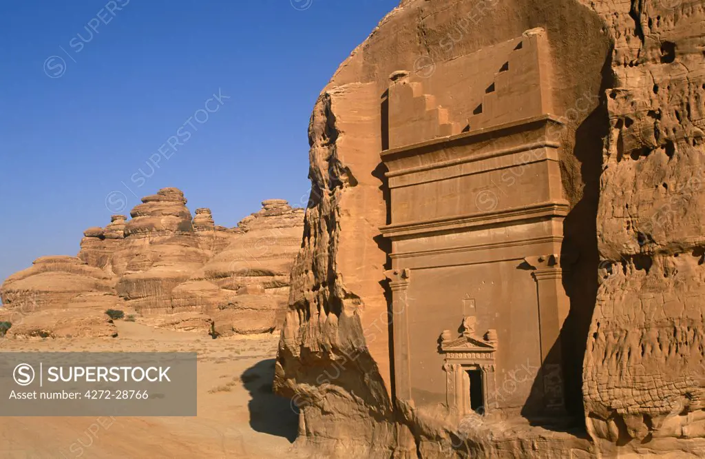 Saudi Arabia, Madinah, nr. Al-Ula, Madain Saleh (aka Hegra). Now a UNESCO World Heritage Site, the ancient remains of Qasr al-Bint - a cluster of rock-cut tombs and part of an ancient Nabatean settlement - stand amidst imposing cliffs and striking rocky outcrops.