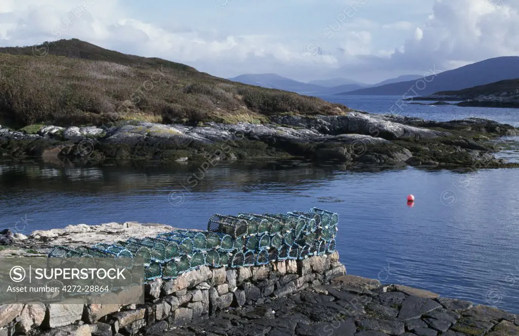 Lobster pots lined up on the small harbour wall at Amhuinnsuidhe