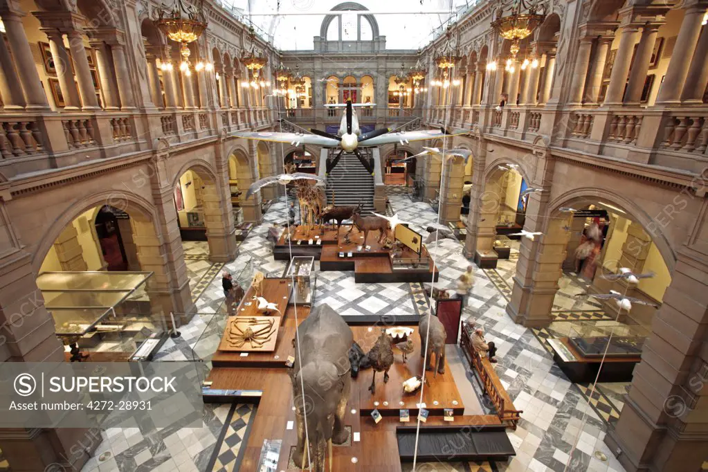 Scotland, Glasgow. A Spitfire suspended above animal displays in the Kelvingrove Art Gallery and Museum.