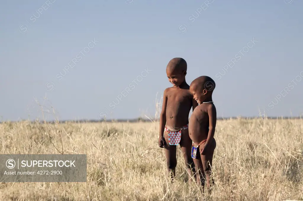 Botswana, Makgadikgadi. Bushmen children standing in the dry grasses of the Kalahari