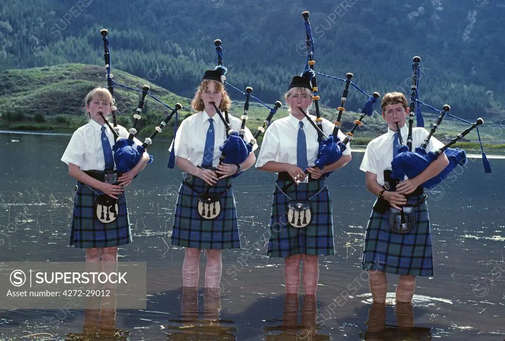 Young pipers cooling down in the loch during a break in the piping competition  Glenfinnan Games