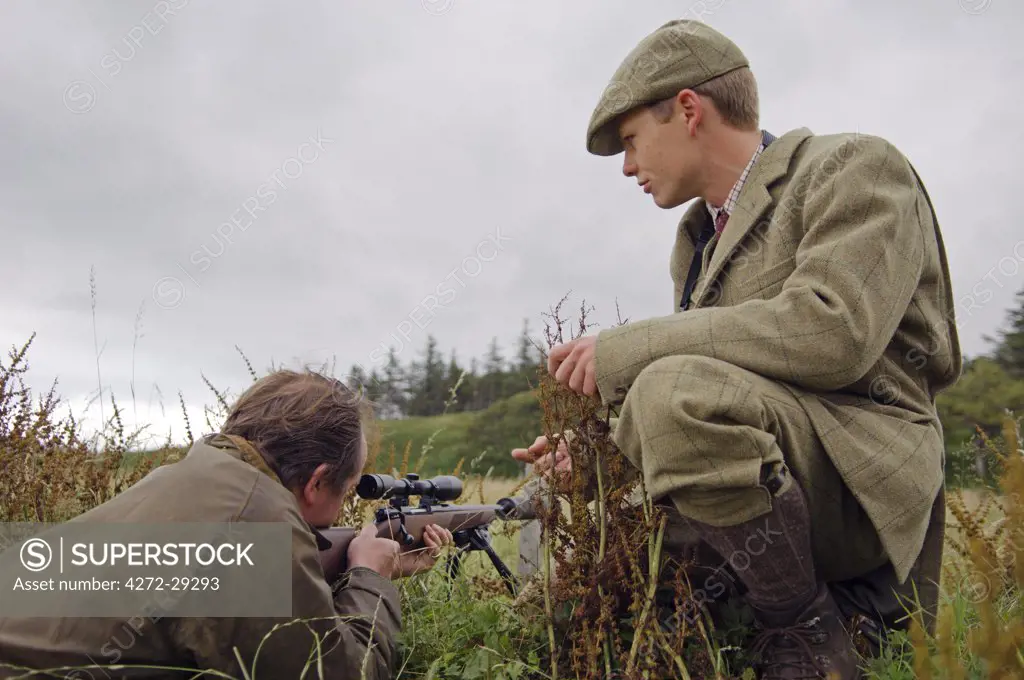 Benmore Estate stalker, Donald Bissett, watches as a guest sights his rifle on the range at Knock House before going out on the hill stalking red deer