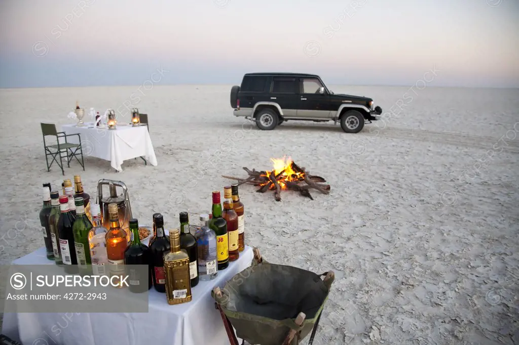 Botswana, Makgadikgadi. A romantic dinner for two is set up at sunset on the empty Makgadikgadi saltpans.