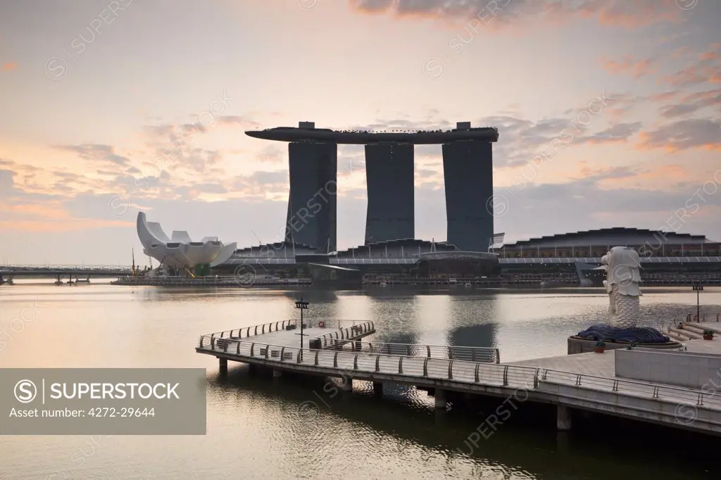 Singapore, Singapore, Marina Bay.  The Merlion Statue at dawn, with the Marina Bay Sands in the background.