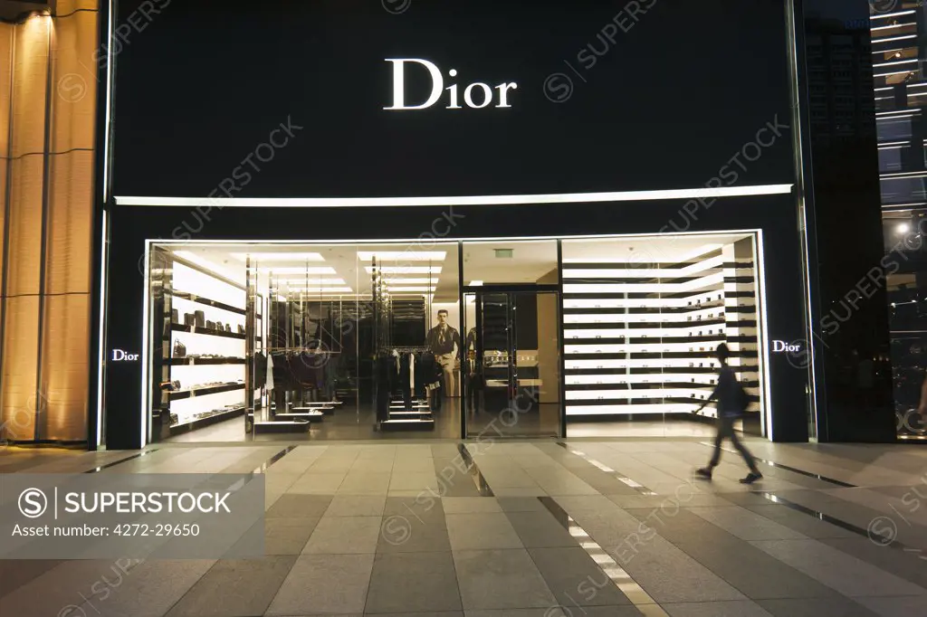 Singapore, Singapore, Orchard Road.  Shoppers outside the Dior store at the ION Orchard Mall.