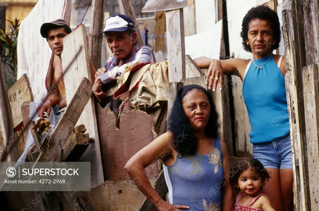 A family in front of their home in a favela in Sao Paulo