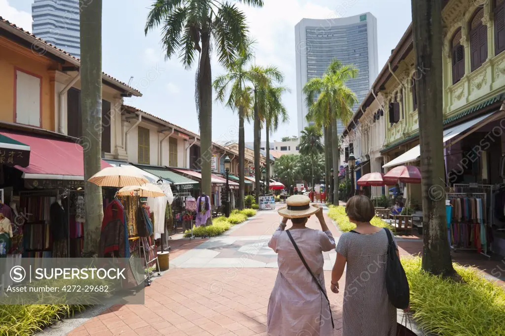 Singapore, Singapore, Arab Quarter.  Tourists shopping in the Bussorah Mall - an area of traditional Malay shophouses.