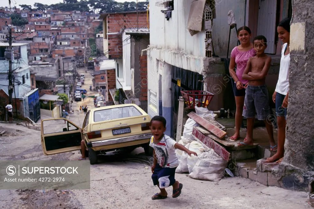 A young boy runs out of his home in a Sao Paulo favela