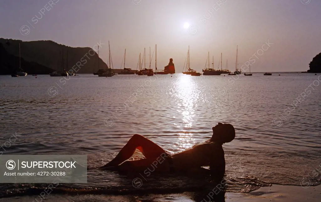 Spain, Balearic Islands, Ibiza. Lorenzo Poccianti on the Benara beach at sunset.