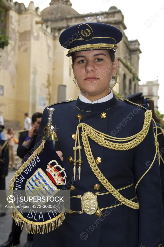 Spain, Andalucia, Seville. A boy in the uniform of the band of one of the Catholic brotherhoods of Seville.