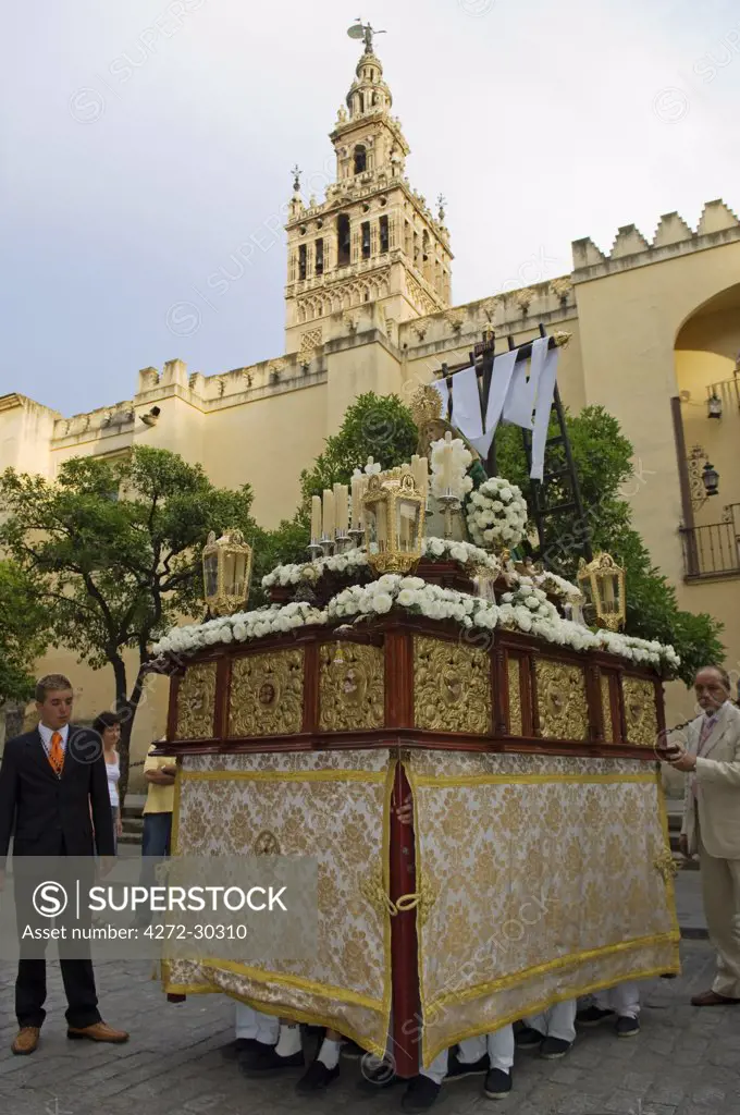 Spain, Andalucia, Seville. A procession past the Cathedral by one of the Catholic brotherhoods of Seville.