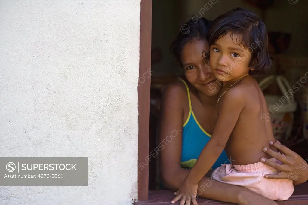 Young Indian girl and mother in the riverbank community of Managia on the Tapajos river, a tributary of the Amazon River in the Amazonas Region of Brazil