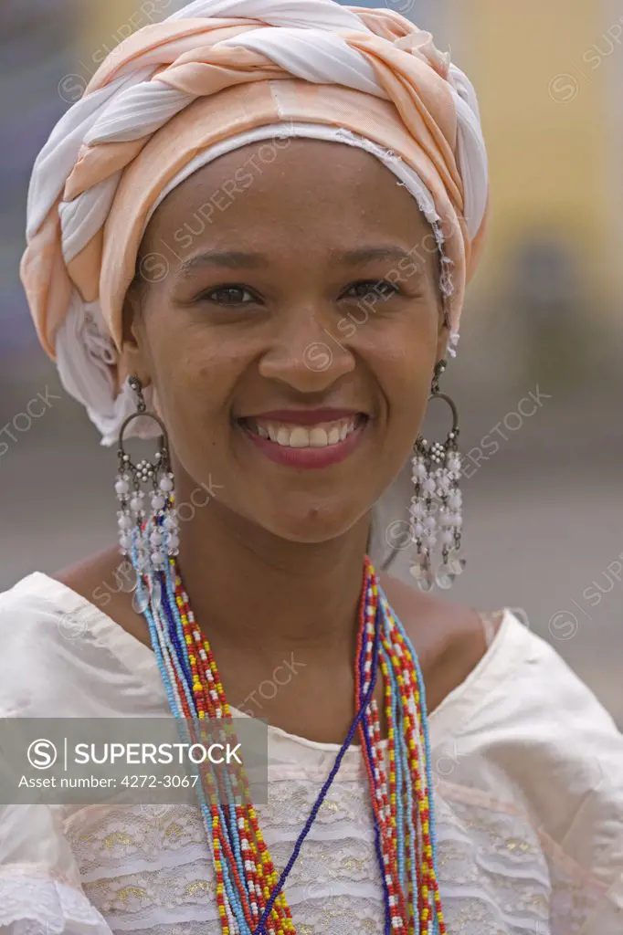 Local lady wearing traditional Bahian dress reflecting the area's colonial past in the UNESCO city of Salvador da Bahia, North East Brazil