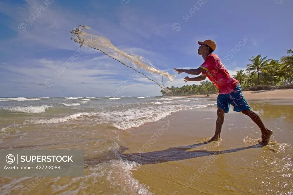 Net fisherman on the shore of the Atlantic Coast of the Tinhare archipelago, Bahia, north east Brazil