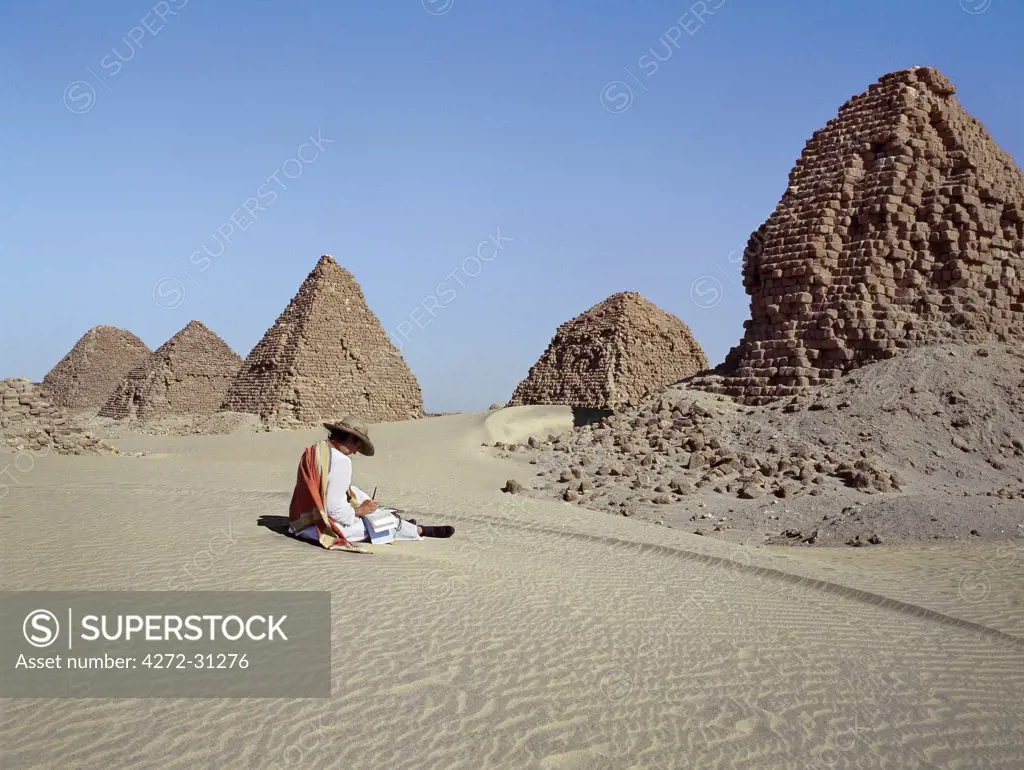 A tourist at the ancient pyramids at Nuri date between 700BC and 300BC.  Nineteen kings and fifty three queens from all the dynasties of the Kingdom of Cush are buried in these pyramids including Taharqa, the famous Black Pharaoh who ruled over Egypt in the 7th century BC until the Assyrians expelled him from Egypt.