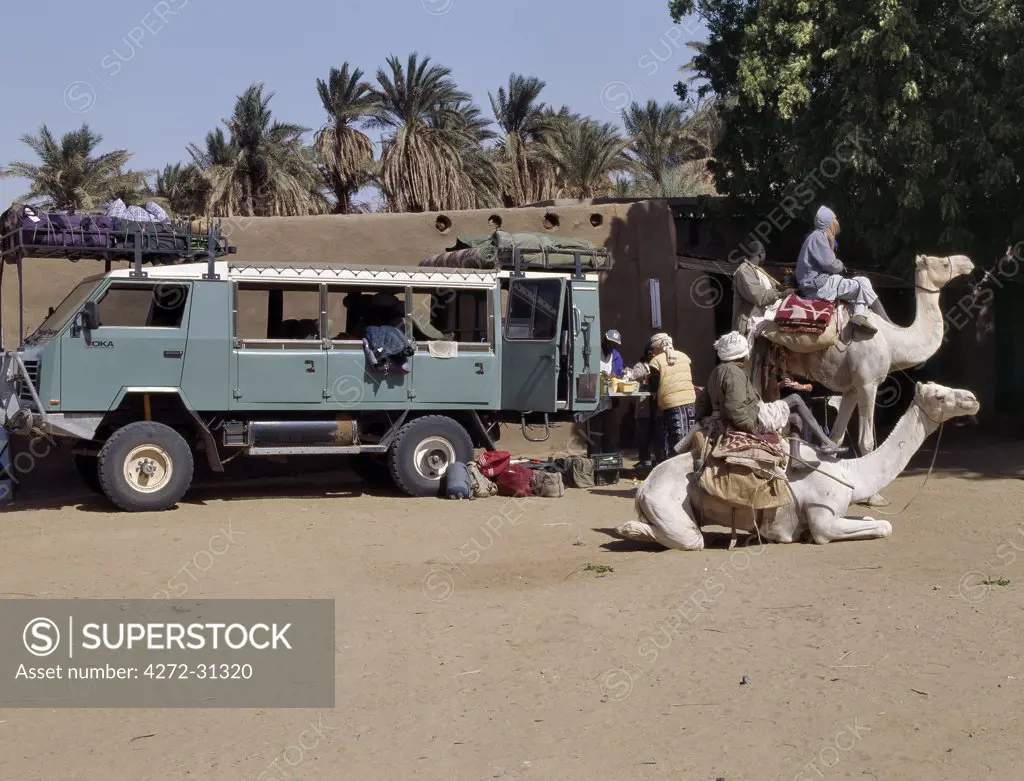 Ancient and modern transport meet at Delgo. The large 4x4 cross-country vehicle takes tourists to the ancient sites of Northern Sudan.