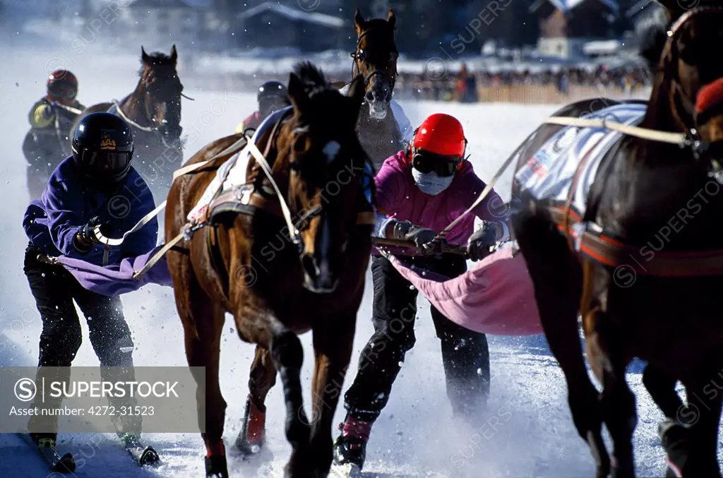 Skijouring, skiing behind a race horse at full gallop, on the frozen lake at St.Moritz, Switzerland.