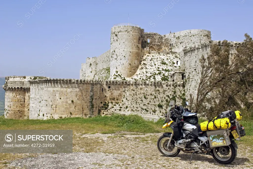Syria. Motorbike in front of the crusader castle of Krak des Chevaliers.