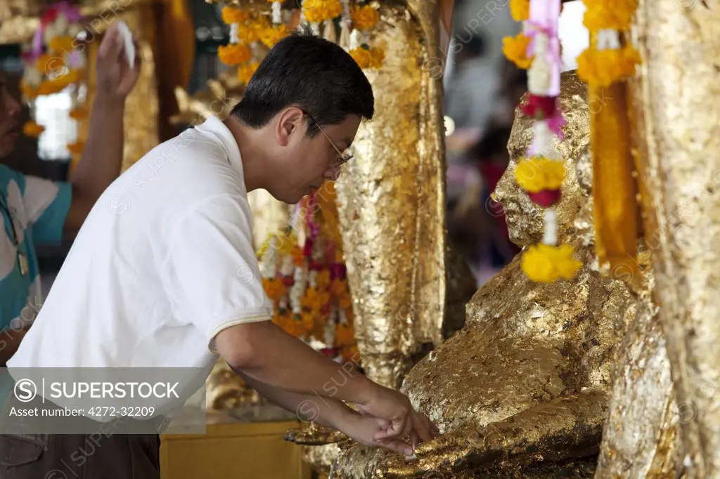 Bangkok, Thailand. Praying at a buddhist temple