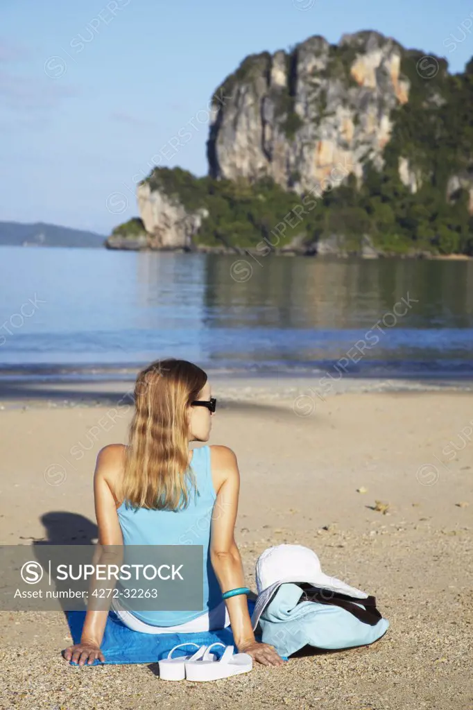 Woman relaxing on Hat Rai Leh West beach, Railay, Krabi Province, Thailand (MR)
