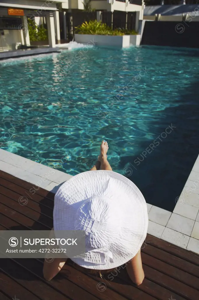 Woman relaxing by pool in Bhu Nga Thani Resort and Spa, Railay, Krabi Province, Thailand (MR)