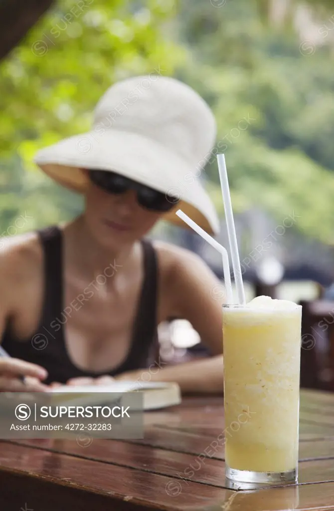 Woman at beachside restaurant with pineapple drink, Railay, Krabi Province, Thailand (MR)