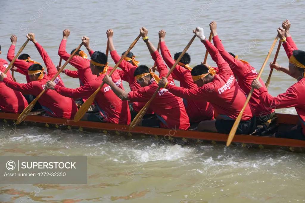 Thailand, Nakhon Ratchasima, Phimai.  Longboat team racing at the Phimai festival boat races.  Longboat racing is a Thai tradition dating back 600 years, usually held at the end of the Buddhist Rains Retreat in October & November.