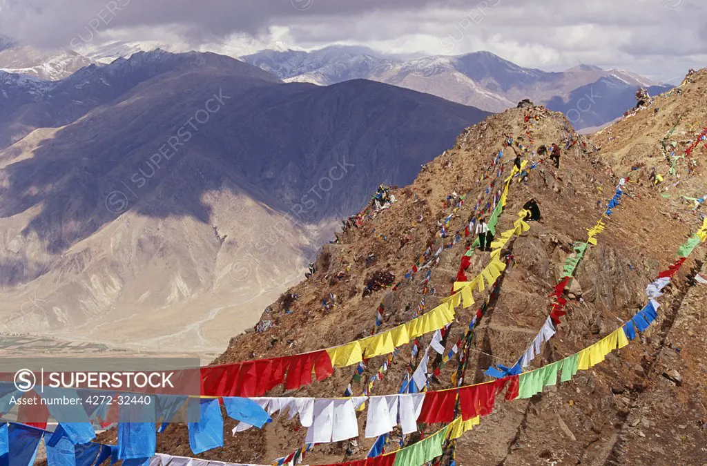 Ganden Monastery.  Prayer flags mark the limit of pilgrims excursions into the hills around Ganden.  They are usually strung around sacred places to purify the air and pacify the gods, and their fluttering is believed to release their written prayers into the heavens.