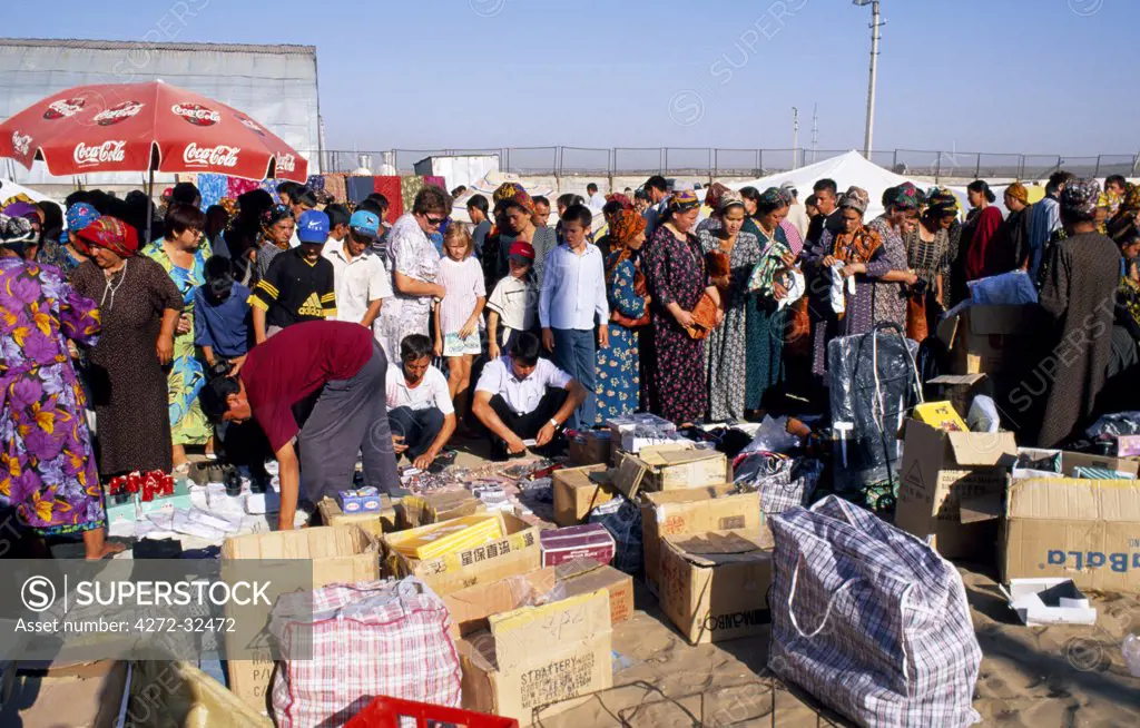 Turkoman women and families shopping amongst the stalls at  the Tolkuchka Bazaar